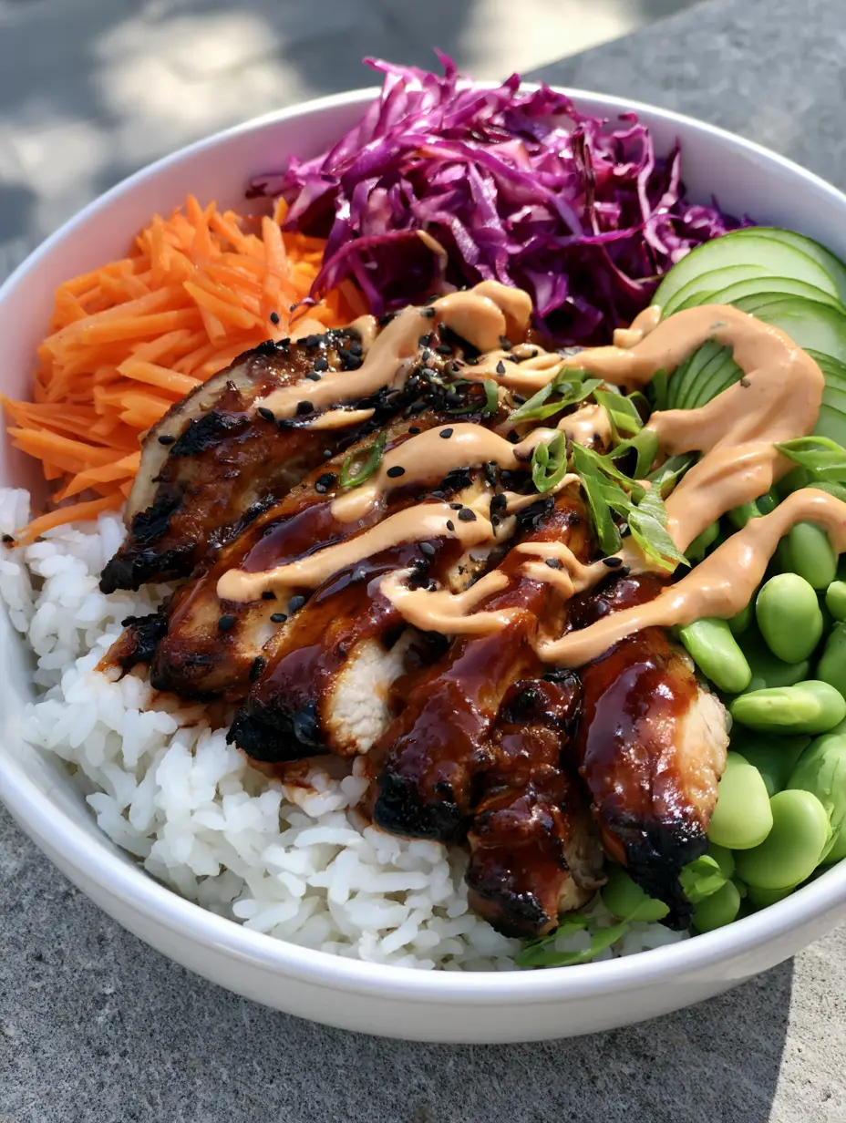 Korean BBQ Chicken Bowls with Creamy Gochujang Sauce 3 Close-up of seared caramelized chicken breast in a white bowl with vibrant vegetables and creamy sauce. (Korean BBQ Chicken Bowls)