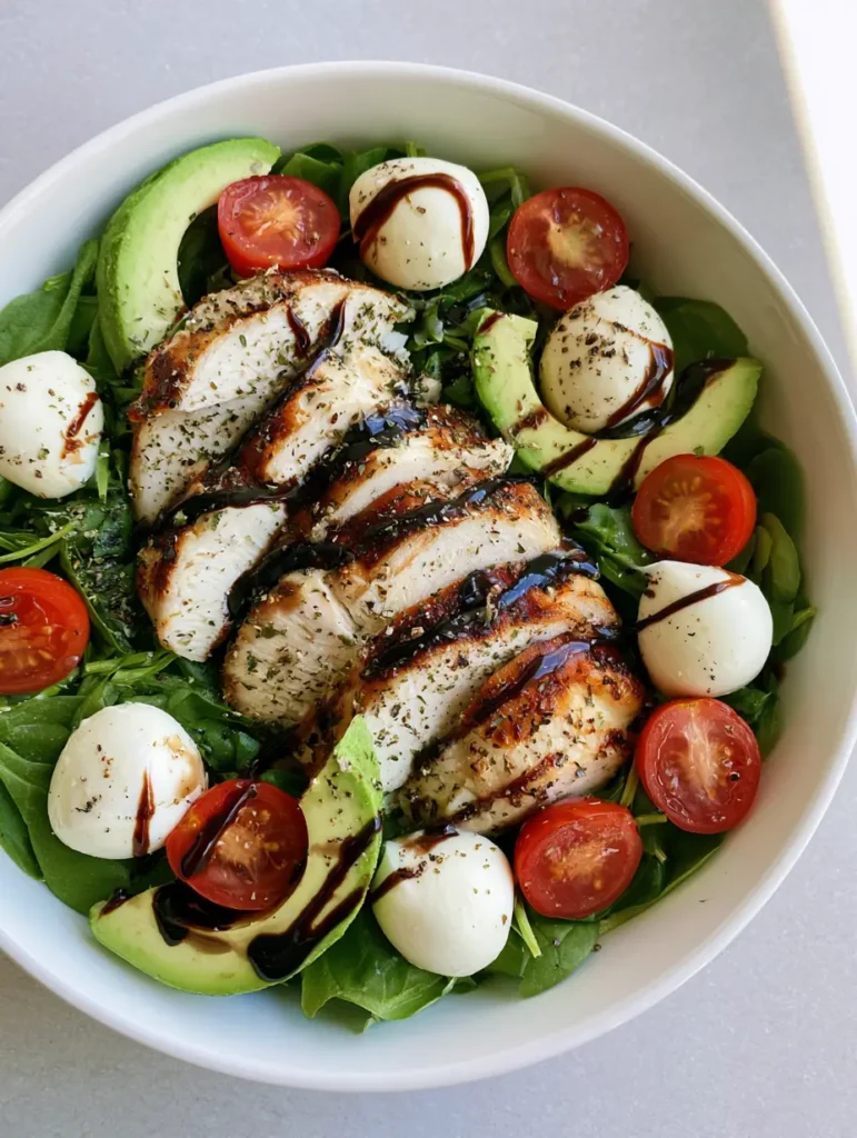 Close up of thick balsamic vinaigrette drizzled over Baked Chicken Salad.