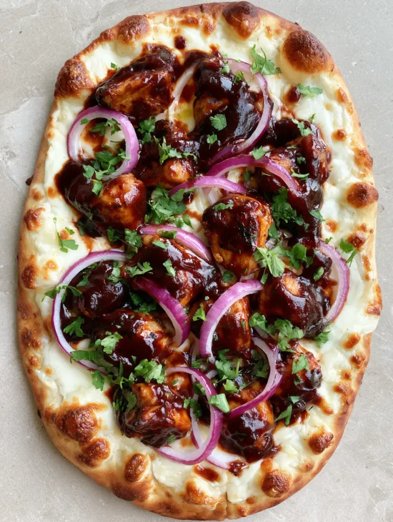 Golden-brown toasted flatbread with slightly charred edges and vibrant red onion rings.