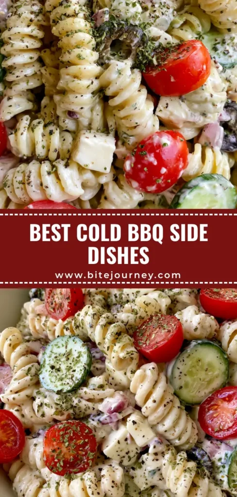A top-down shot of a large white bowl filled with creamy rotini pasta salad, red tomatoes, and cucumbers. (cold side dishes for bbq)