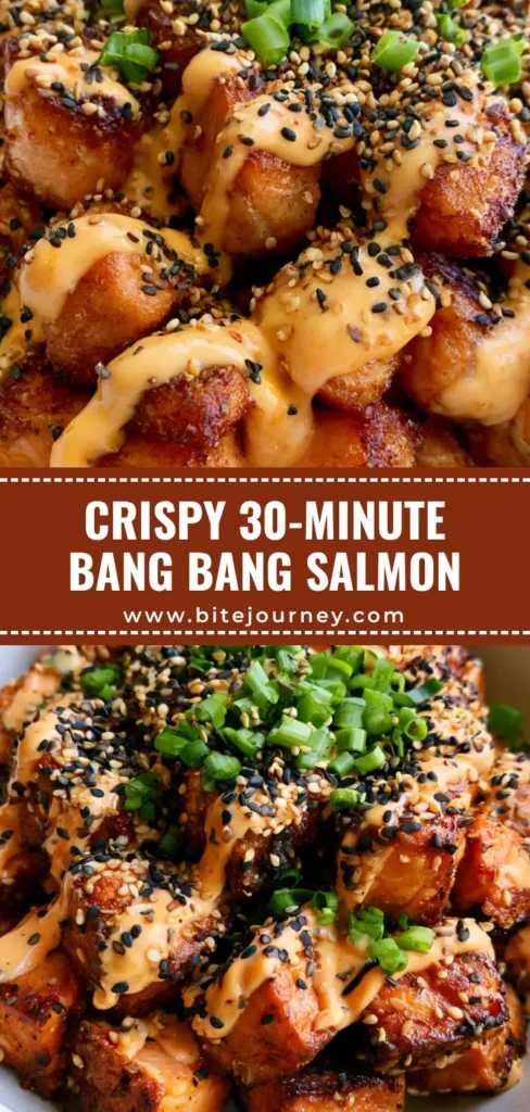 A close-up, top-down view of Bang Bang Salmon Bites in a white bowl, drizzled with orange sauce and sprinkled with sesame seeds and scallions.
